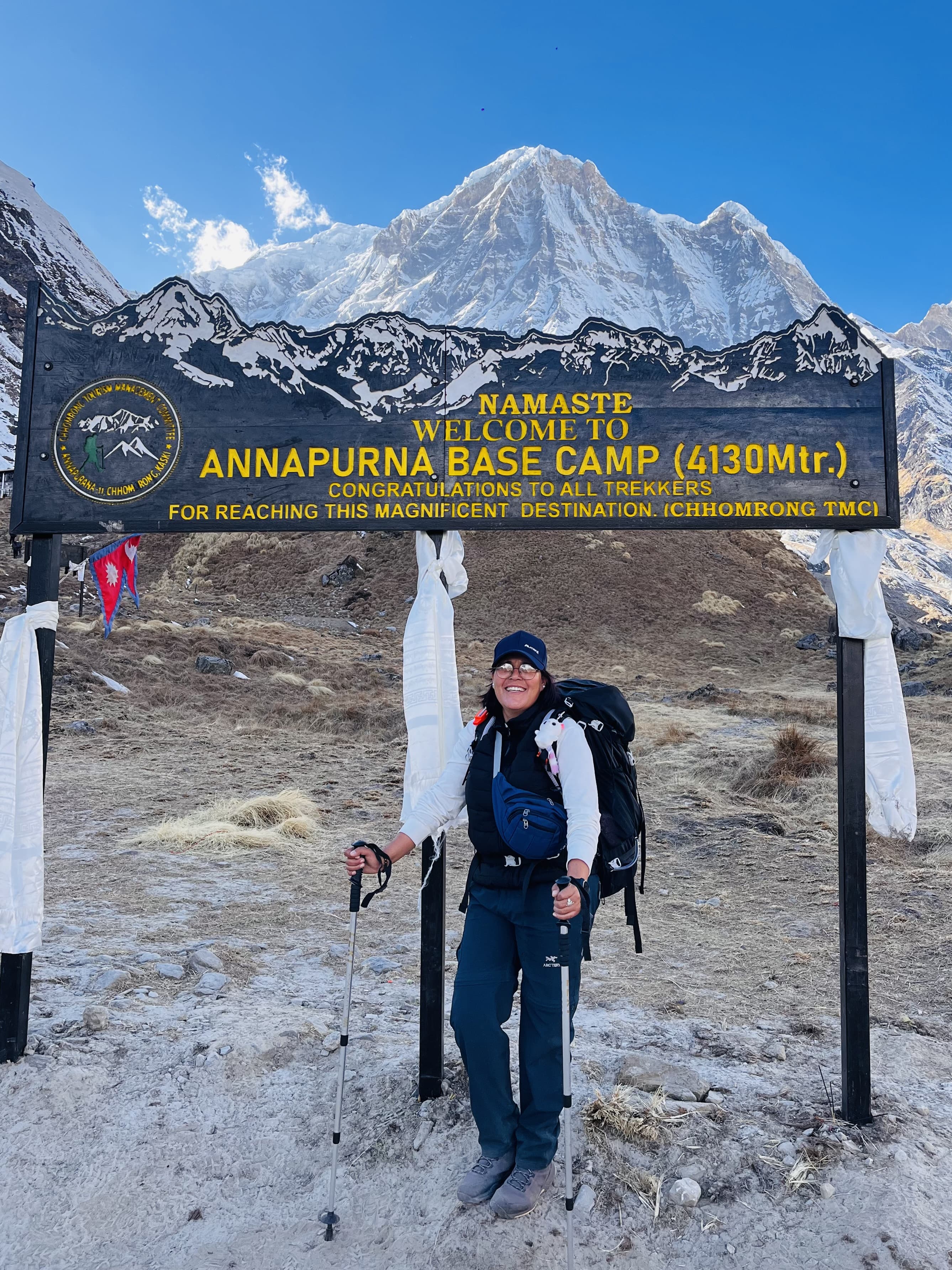Profile photo of a trekking guide wearing a blue cap and sunglasses in the mountains